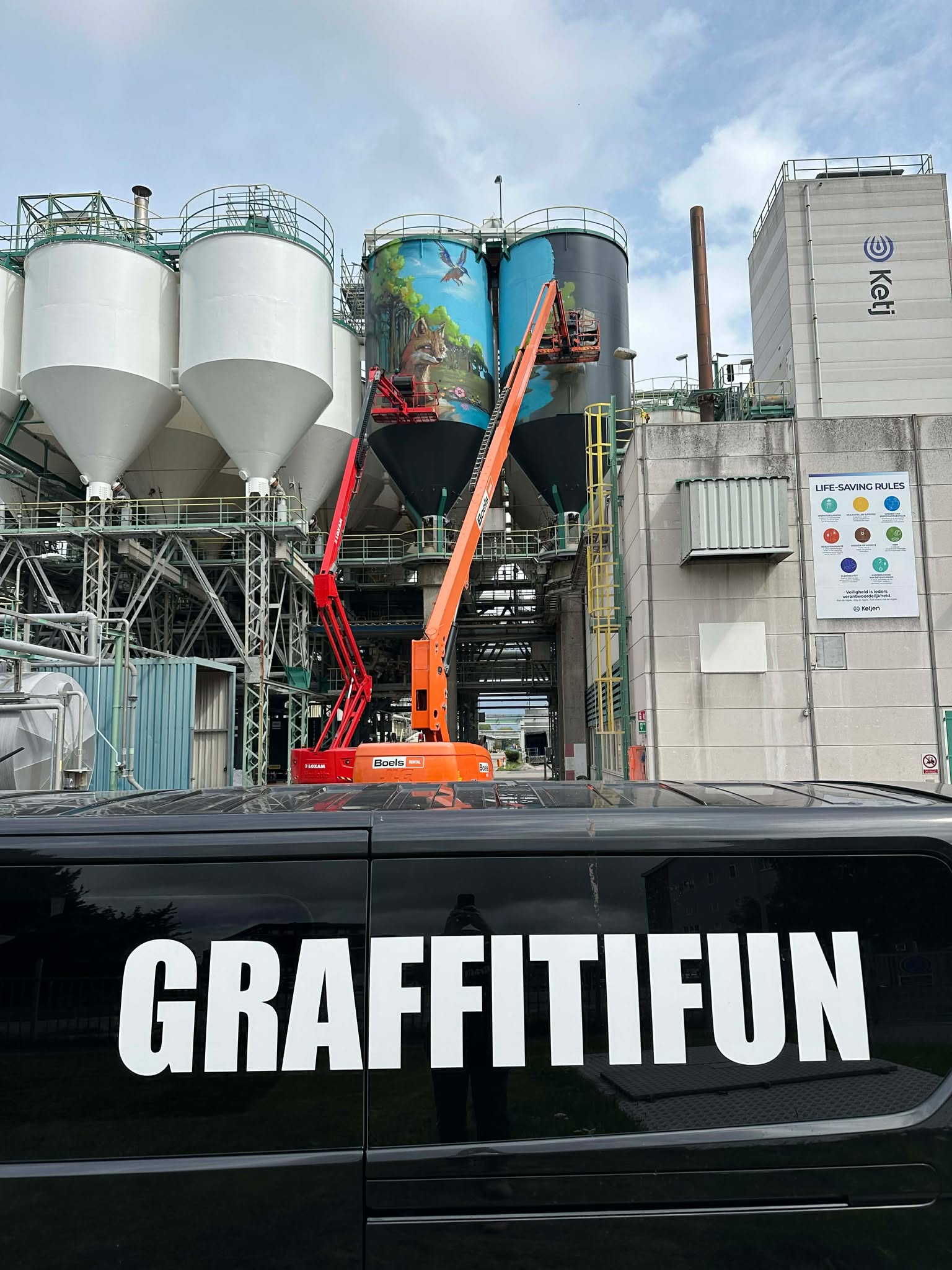 Colorful street art covering an industrial silo building