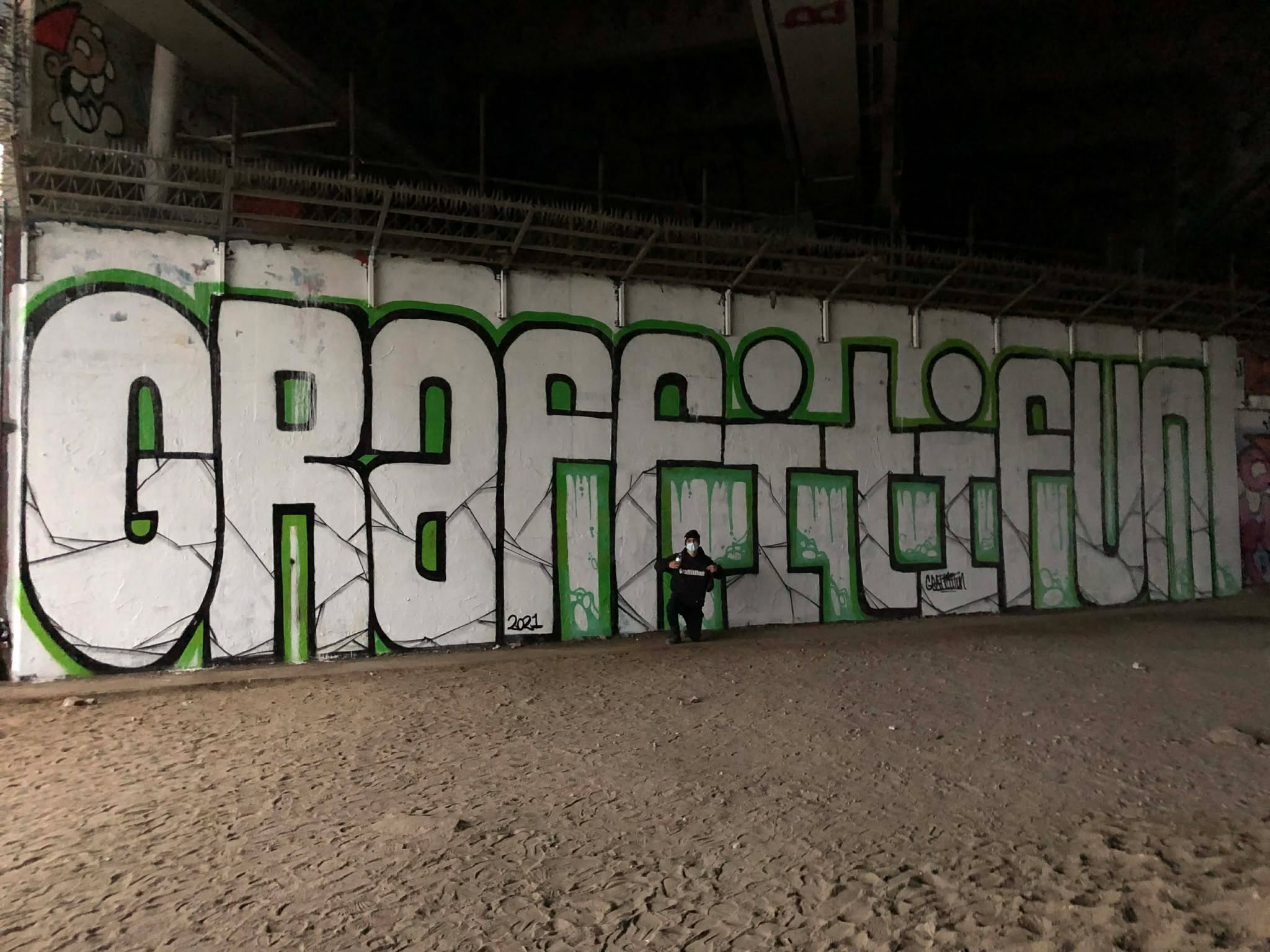 Large team working on a graffiti mural